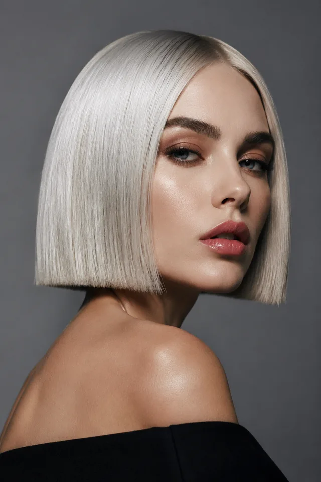 Woman with a platinum-blonde bob and side-swept front pieces